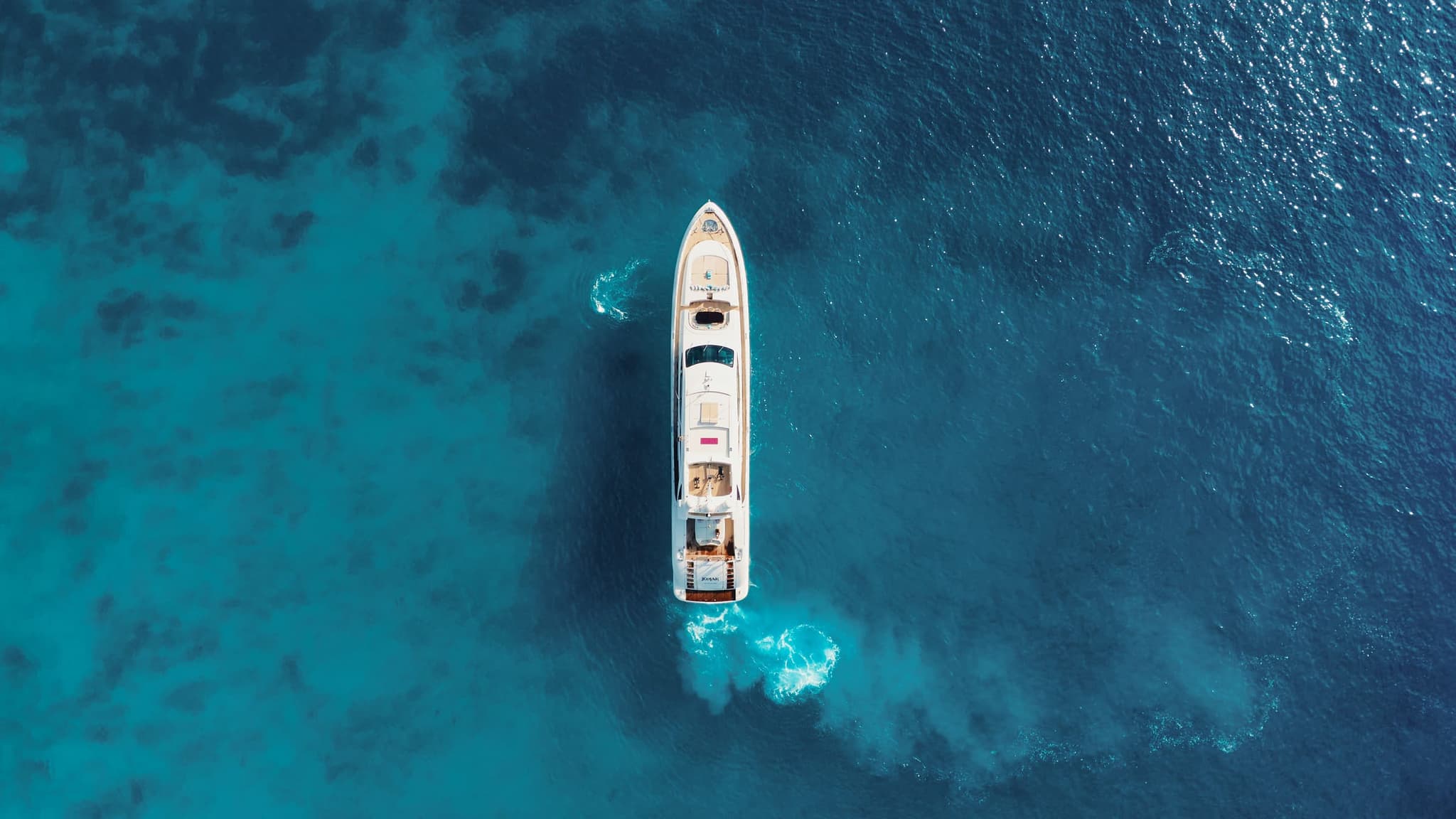 Aerial view of yacht near a turquoise beach